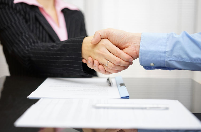 business partner and client are handshaking over signed contrac business partner and client are handshaking over signed contrac